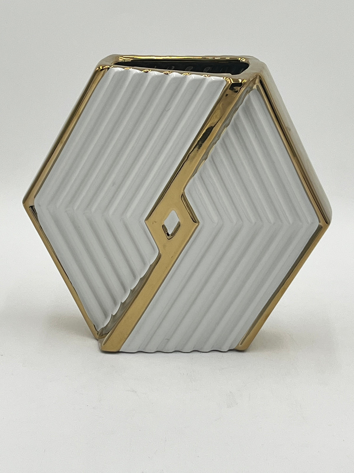 A hexagonal ceramic vases with gold trim in white, 9" x 4" and 3 lbs, ideal for floral designs. Available at floralsuppliespoint1.com