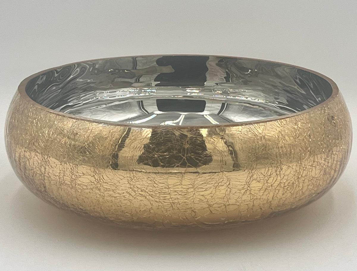 The Crackle Halo 4x9.5 Op by Floral Supplies Point is a round bowl featuring a gold crackled glass finish and a reflective silver interior, ideal for displaying floral arrangements against a simple light background.