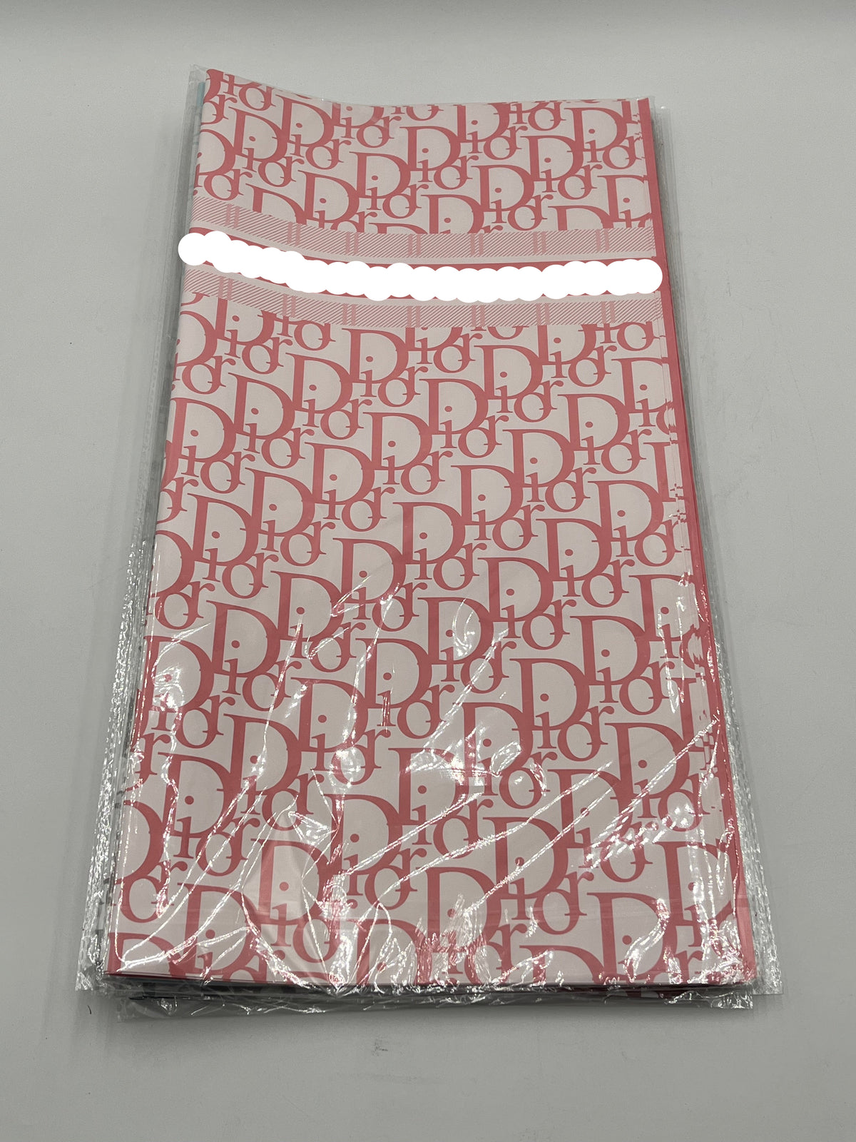 22x22 inch floral wrapping paper with iconic CD monogram in Pink.Sold by floralsuppliespoint1.com for $9.99