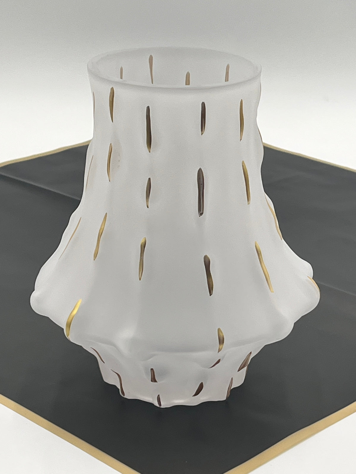 Midnight Ember in matte white vase showcases a dramatic & sculptural silhouette, providing a sophisticated, modern backdrop for the decorative accents.