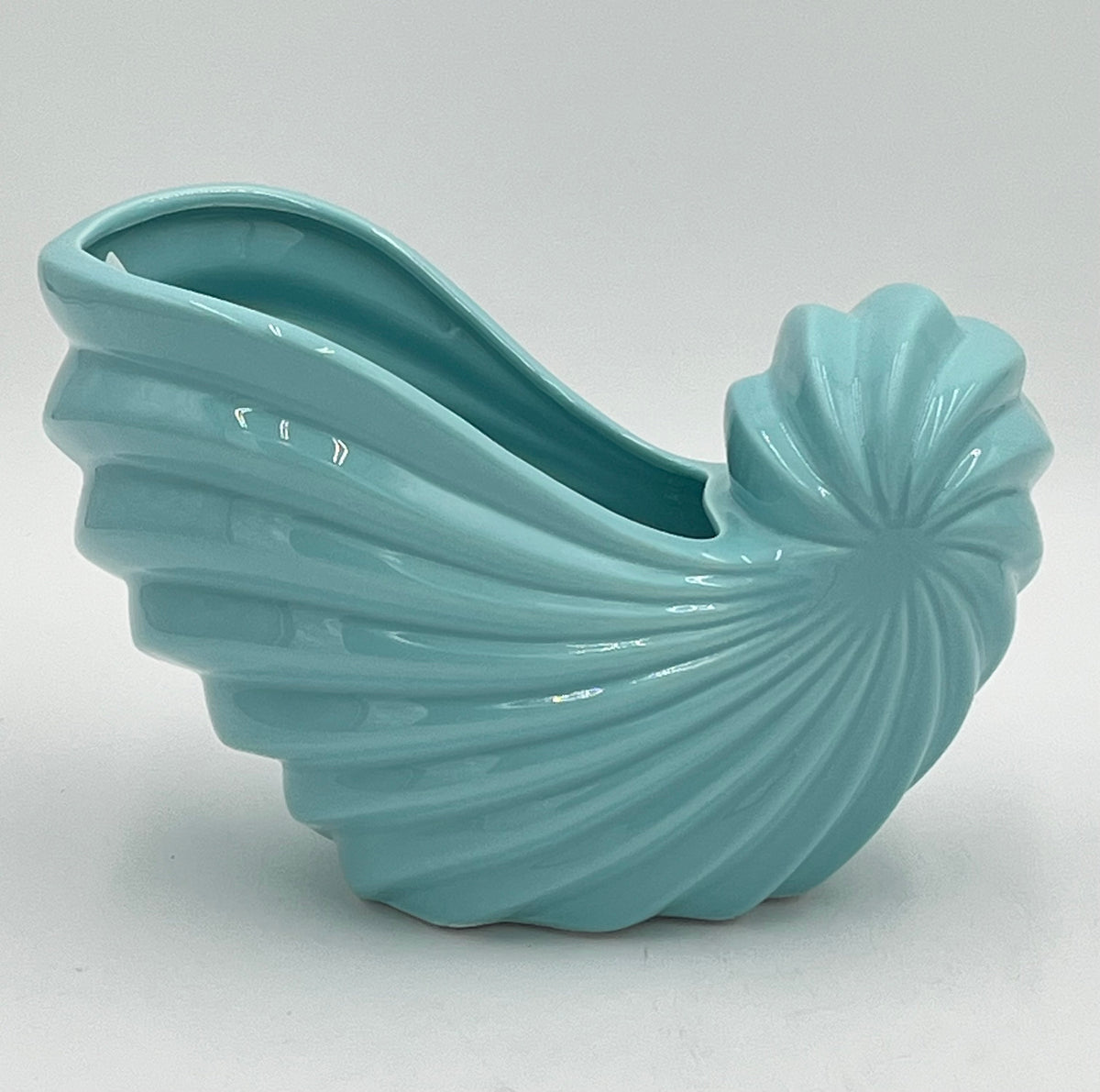 Shellglo ceramic vases in glossy soft aqua with spiral shell design, 6" x 6.5", 1.60 lbs each, sold by floralsuppliespoint1.com. Ideal for coastal floral decor and small arrangements.