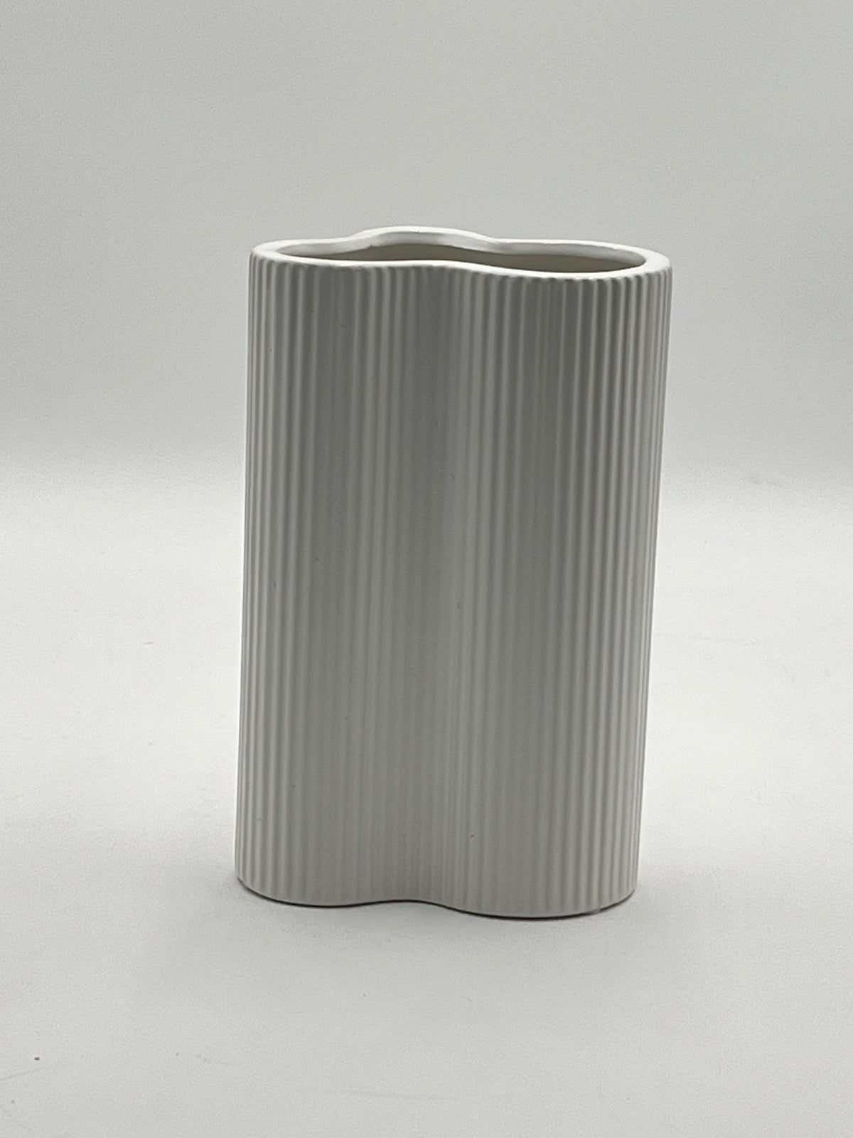Waveline Core ceramic vase in Matte White, with ribbed design, sold by floralsuppliespoint1.com. Each vase measures 9" x 5" and weighs 2.30 lbs, perfect for modern floral arrangements.