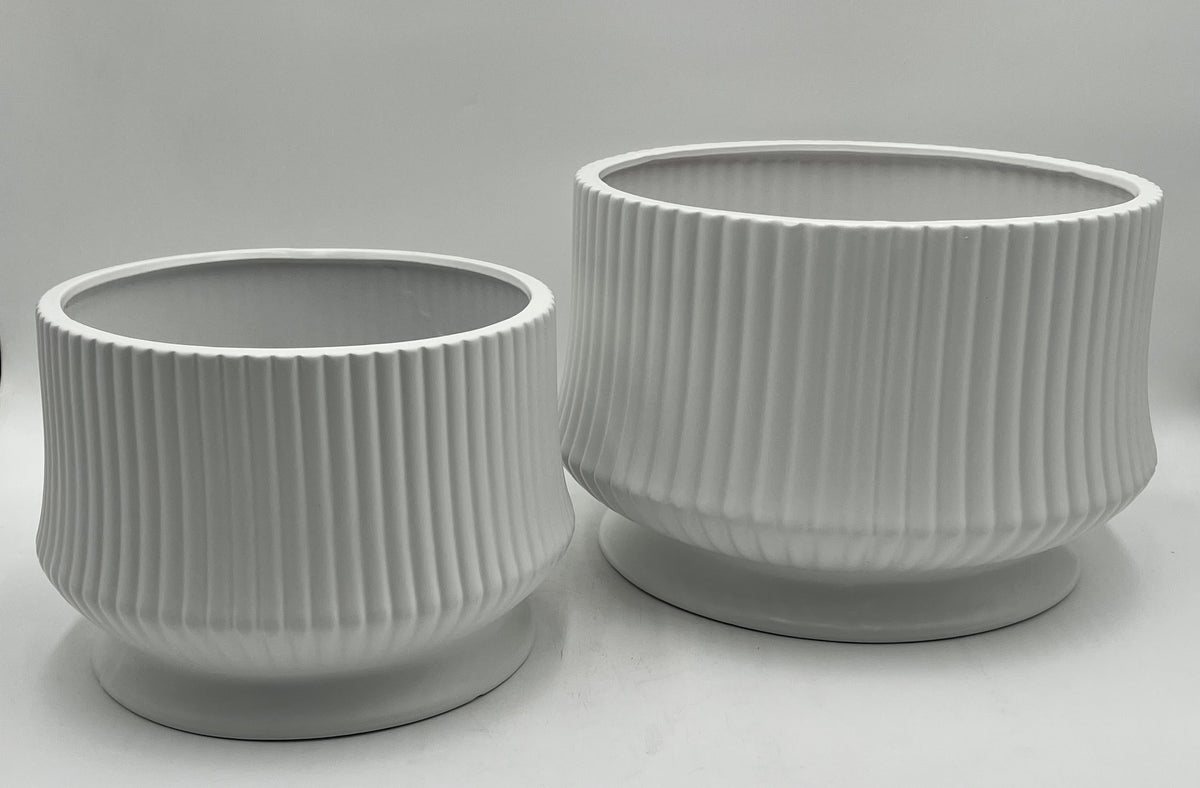 Cove Ridge Set ceramic vases in white with ribbed design and pedestal base, sizes 8"x10.5 Op and 6.5"x8 Op, total weight 11.50 lbs, available at floralsuppliespoint1.com.