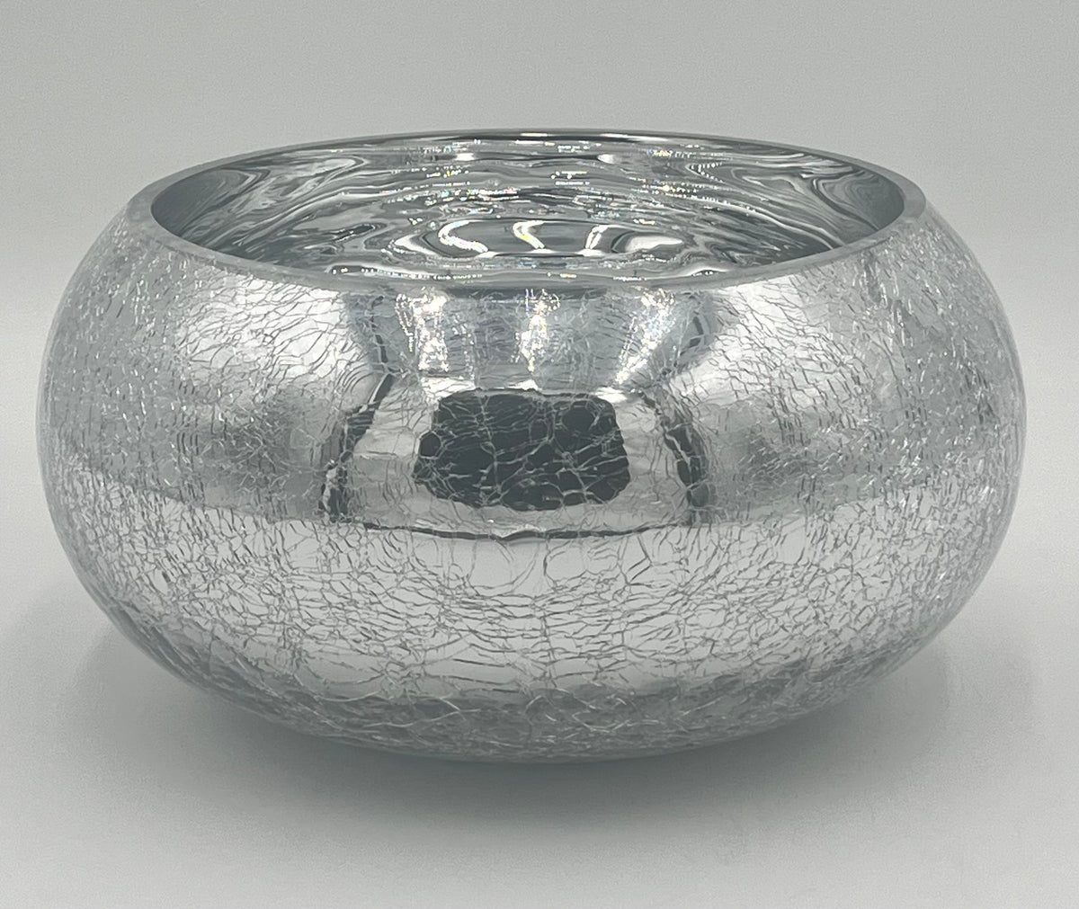The Floral Supplies Point Crystallo Basin 5.25 x 7.25 Op is a round, silver bowl with a wide opening, featuring a reflective crackled exterior and smooth shiny interior, shown against a plain light gray background.