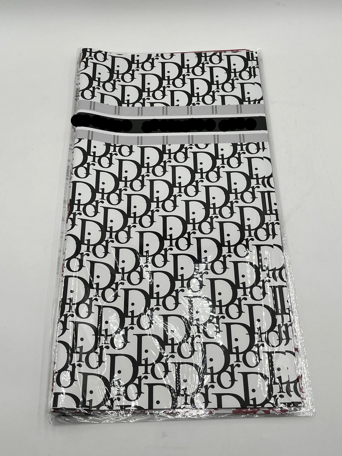 22x22 inch floral wrapping paper with iconic CD monogram in Black.Sold by floralsuppliespoint1.com for $9.99