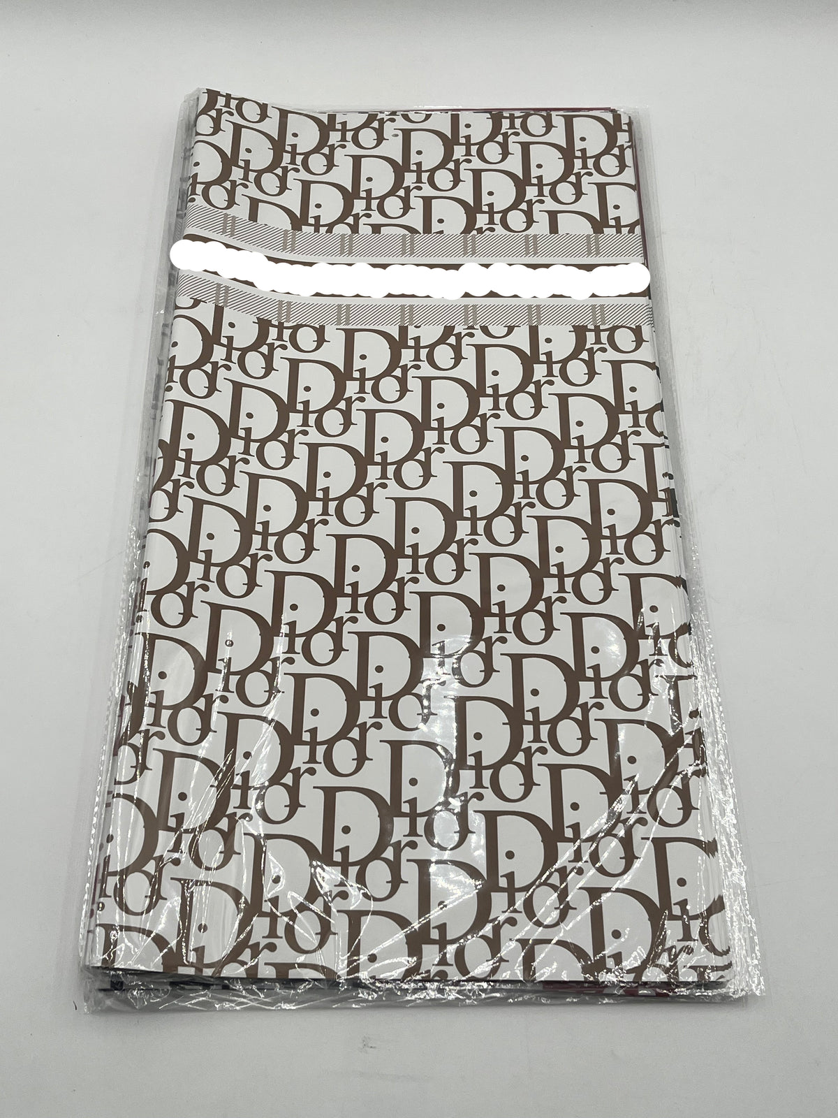 22x22 inch floral wrapping paper with iconic CD monogram in Brown.Sold by floralsuppliespoint1.com for $9.99