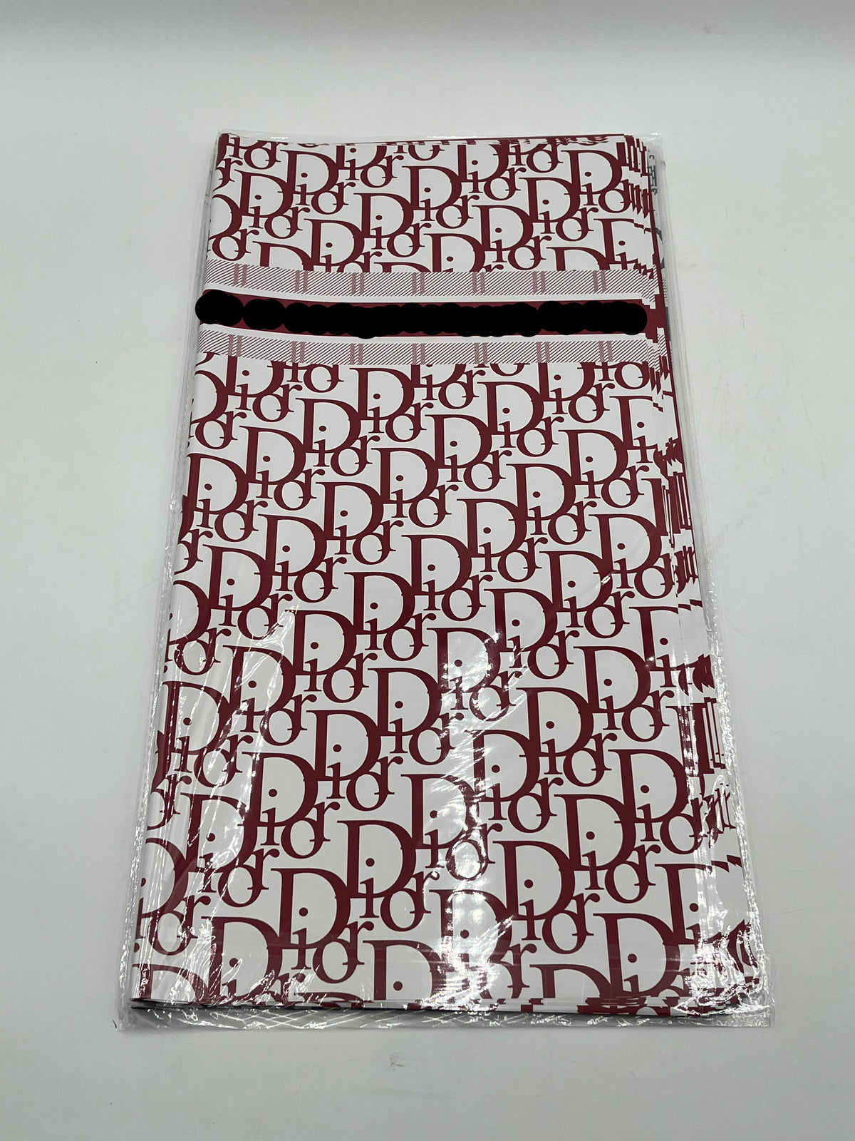 22x22 inch floral wrapping paper with iconic CD monogram in Red Wine.Sold by floralsuppliespoint1.com for $9.99