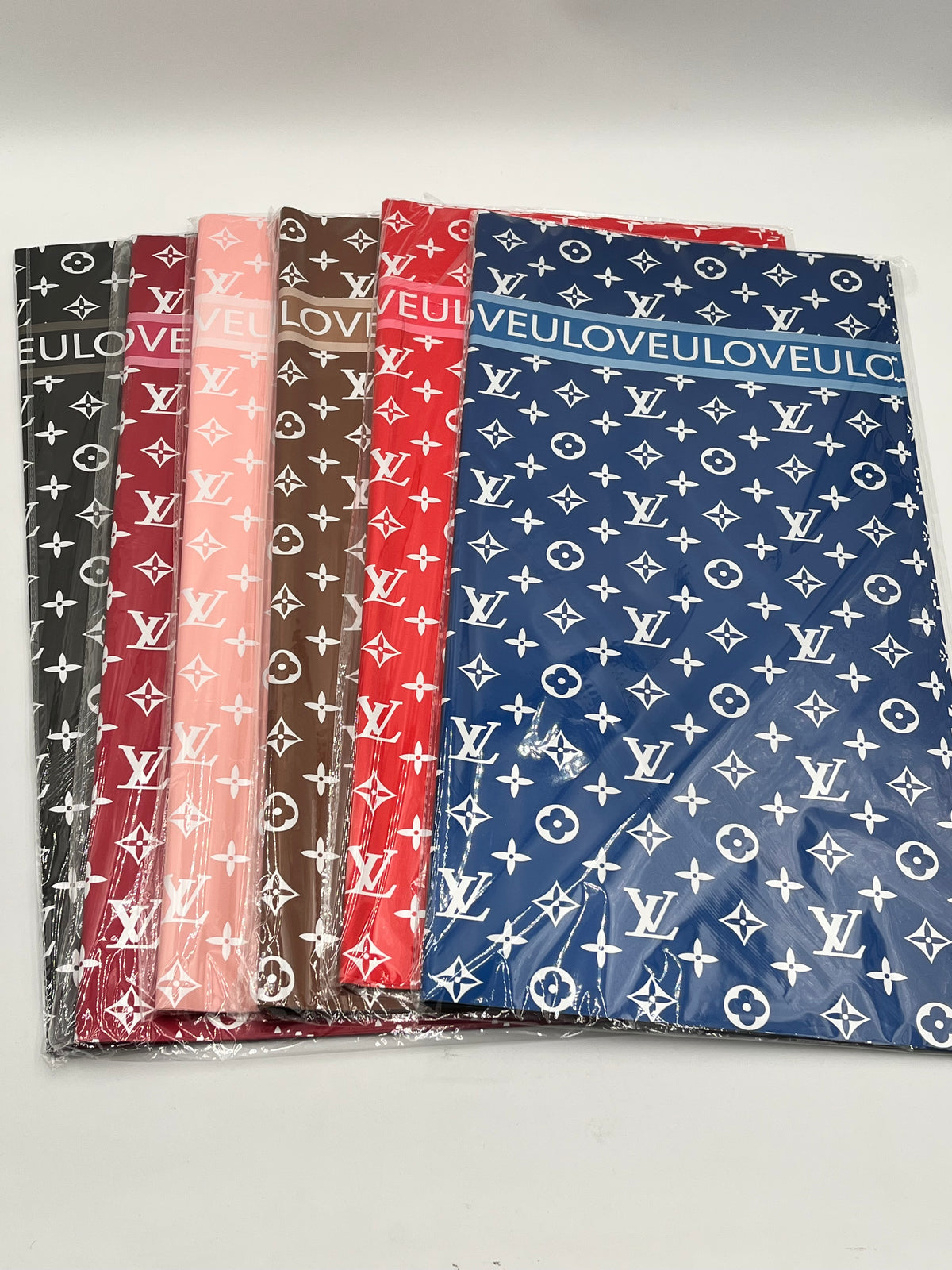 LOVEU LV Luxe Set wrapping paper in Black, Red Wine, Peach, Brown, Red & Blue with iconic LV monogram. Sold by floralsuppliespoint1.com for $9.99