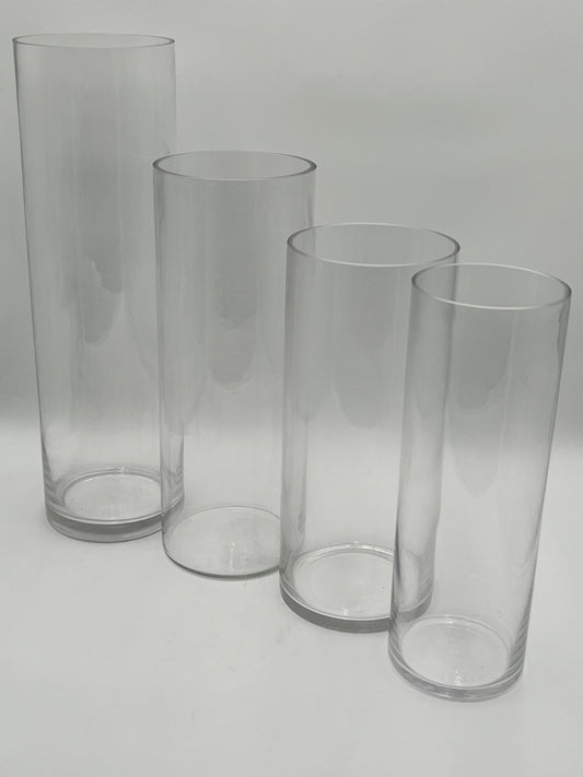 The LuxeGlass Cylinder Collection are clear glass cylinder vases in four sizes, ideal for floral designs, candles, or events. Sturdy, elegant, and sold individually by floralsuppliespoint1.com.