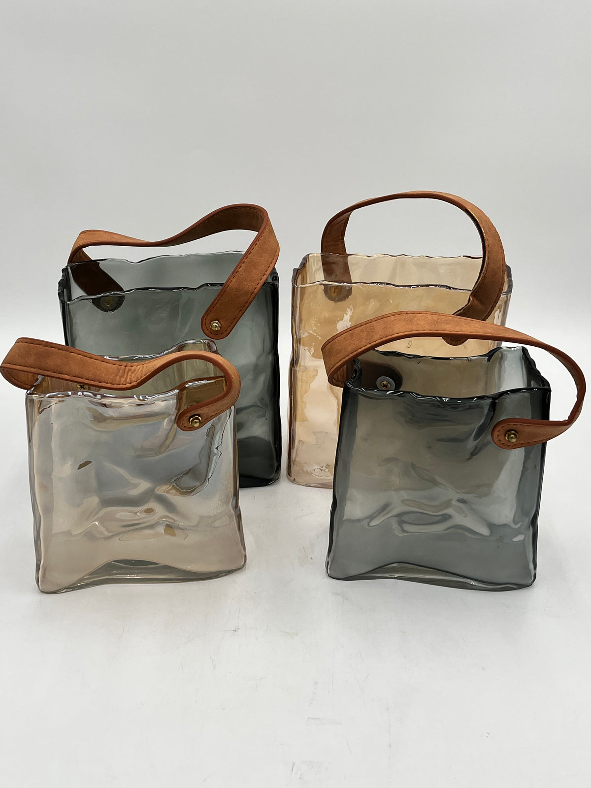 Nomad Tote glass vases with suede handles in smoke gray and champagne beige, 2 sizes. Modern décor sold by floralsuppliespoint1.com