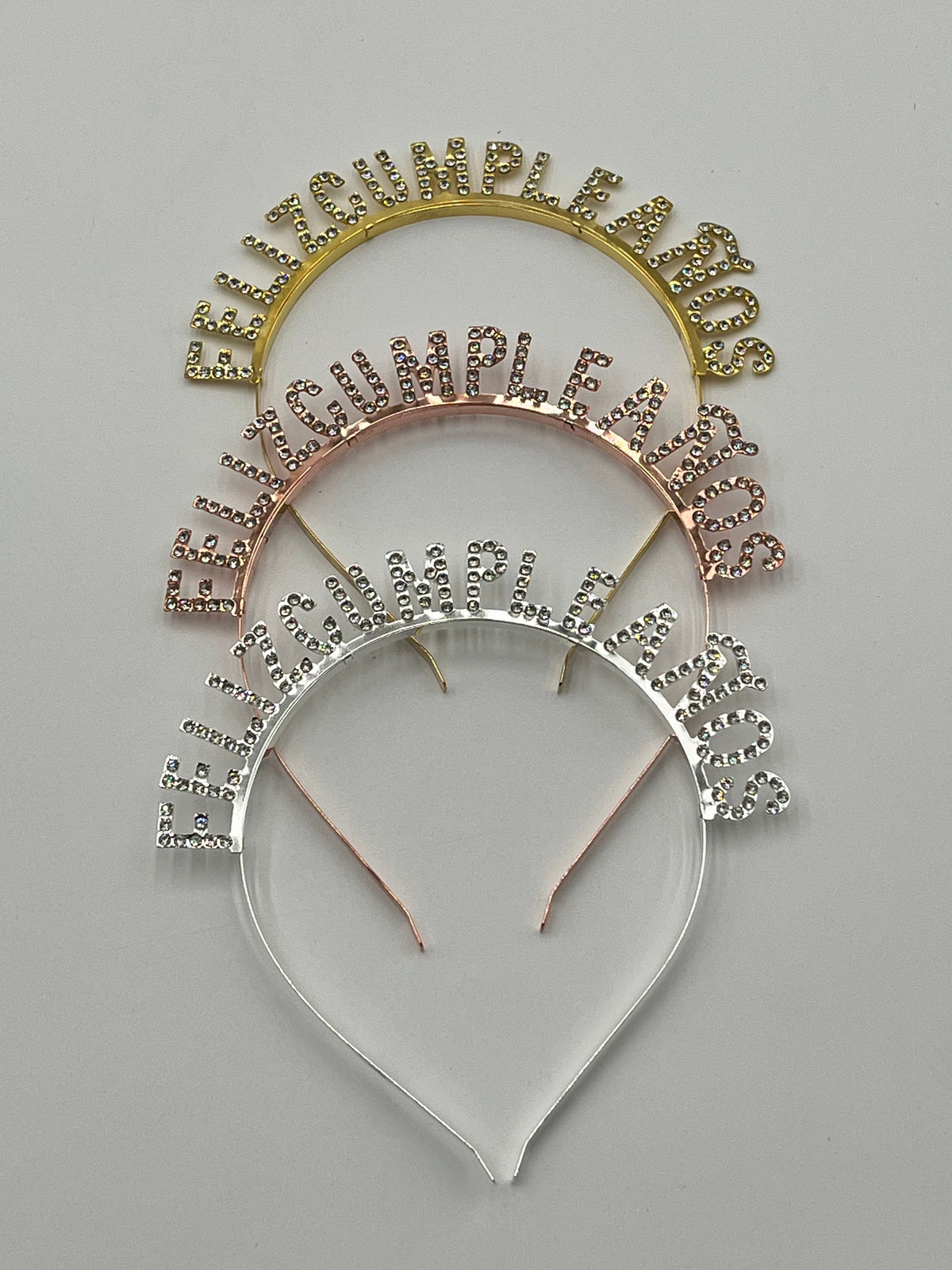 Gold, rose gold & silver Rhinestone "Feliz Cumpleaños" headbands, 5" tall, sold retail & wholesale by floralsuppliespoint1.com.
