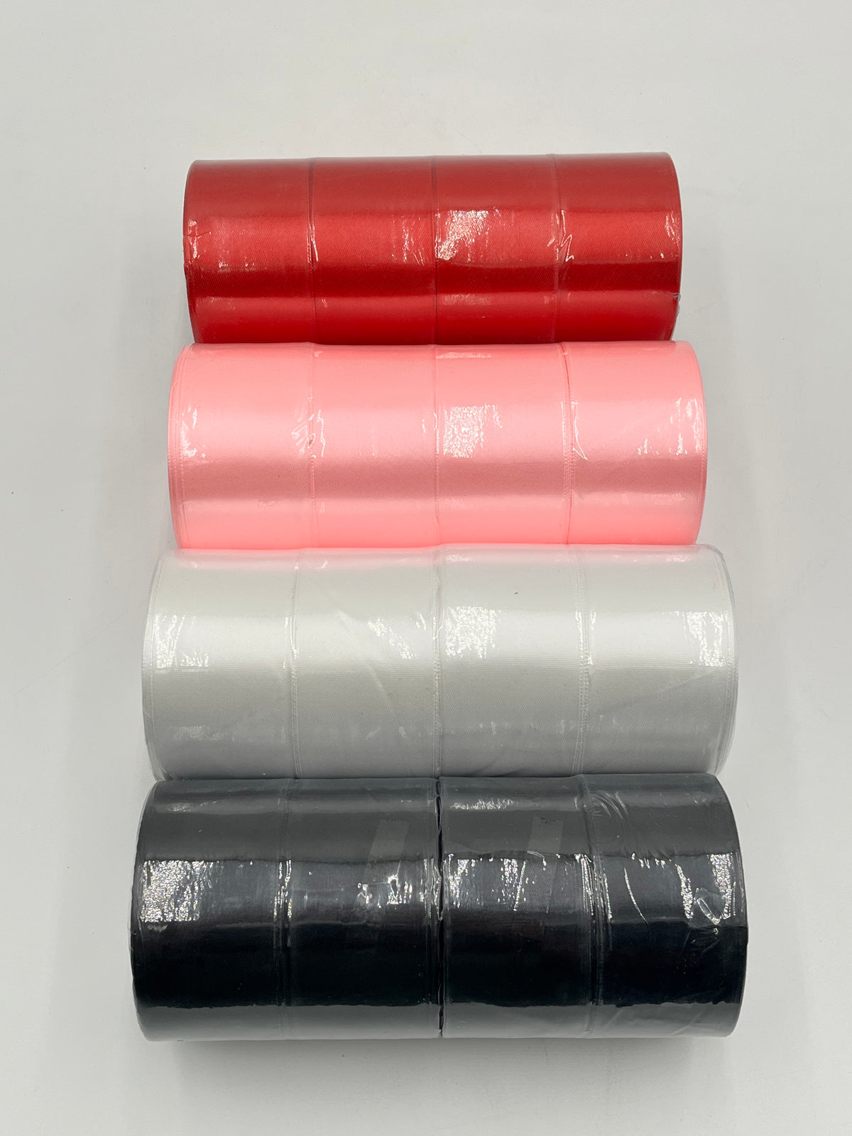 Satin ribbon rolls 1.5" & 2" x 25 yards in Red, Pink, White & Black. Sold individually or in packs by floralsuppliespoint1.com.
