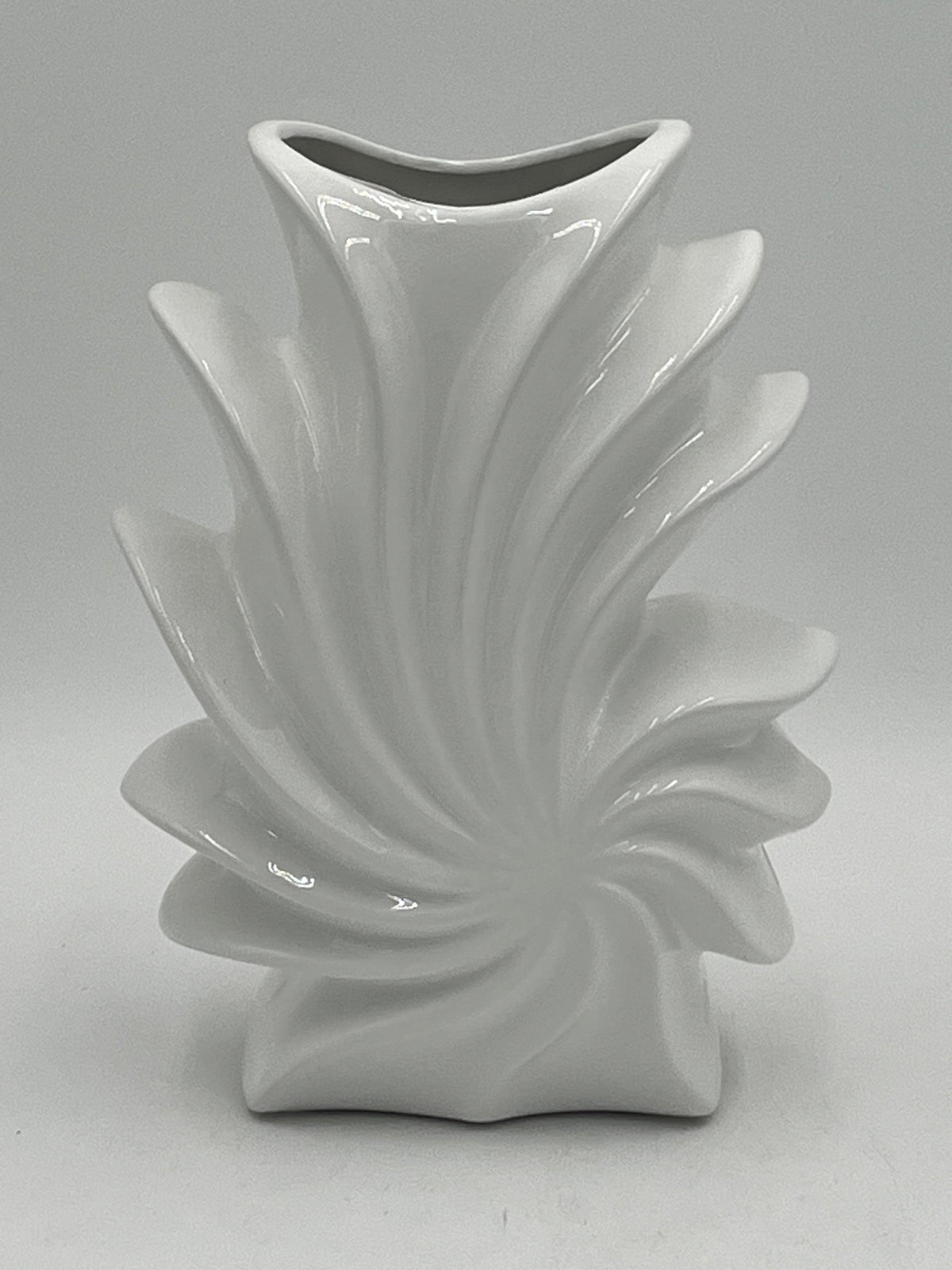 Shellflare ceramic vases in glossy white with sculptural ocean swirl design, 10" x 3.5", 2.10 lbs each, available at floralsuppliespoint1.com. Ideal for bold floral accents.