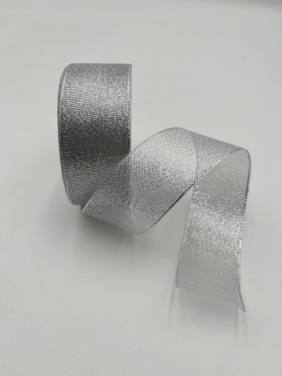 Silver polyester ribbon roll in 2” x 25 yards, ideal for floral design, gifts and crafts. Sold individually by floralsuppliespoint1.com.