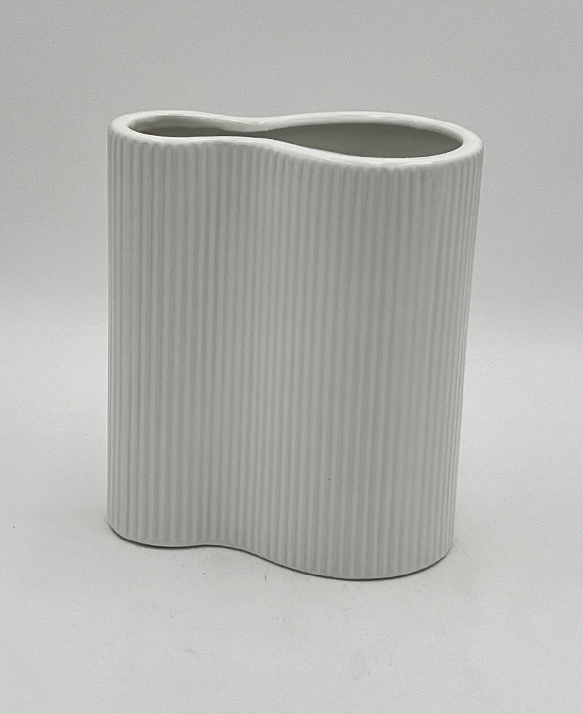 Twin Current vases in matte white with ribbed texture, sold by floralsuppliespoint1.com. Includes medium (8"x6") and small (6"x6") ceramic vases for modern floral designs.