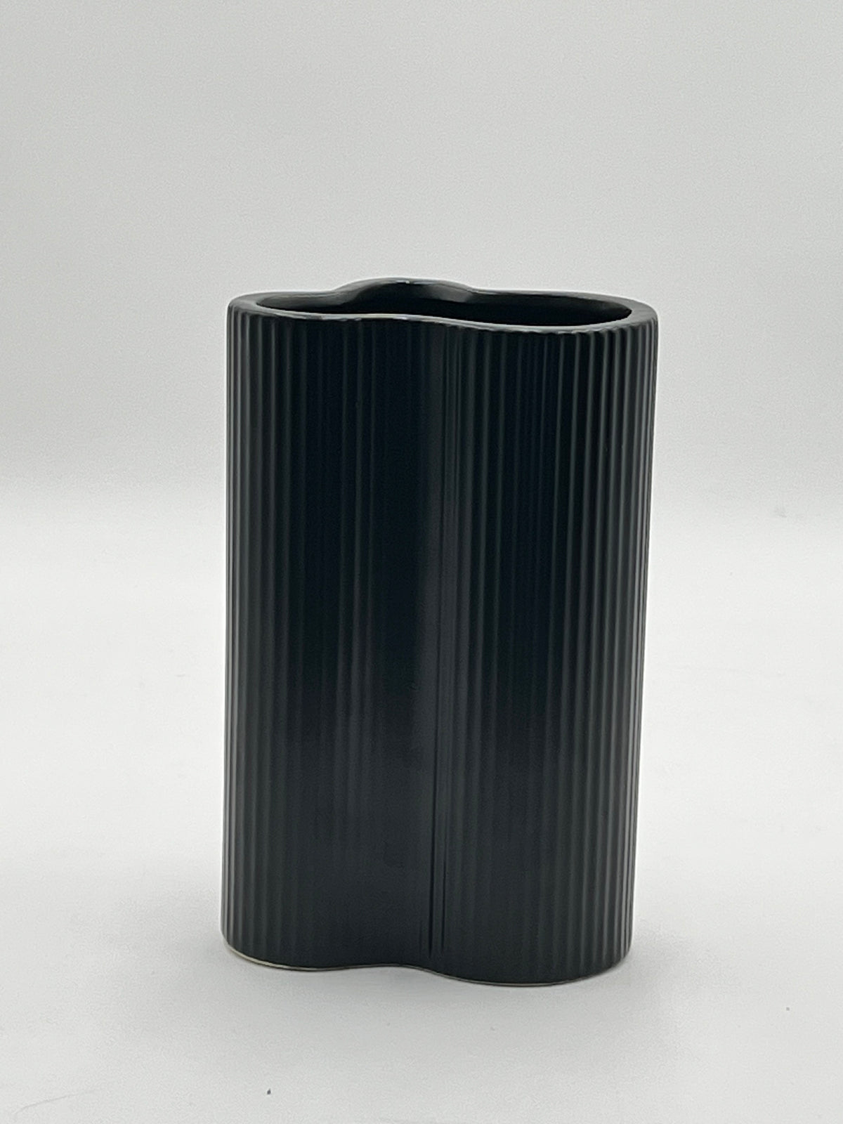 Waveline Core ceramic vase in Matte Black with ribbed design, sold by floralsuppliespoint1.com. Each vase measures 9" x 5" and weighs 2.30 lbs, perfect for modern floral arrangements.